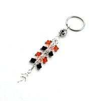 silver skull bead at the top and flame charm at the bottom 