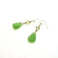 one bi cone shaped light peridot green color crystal bead at the top