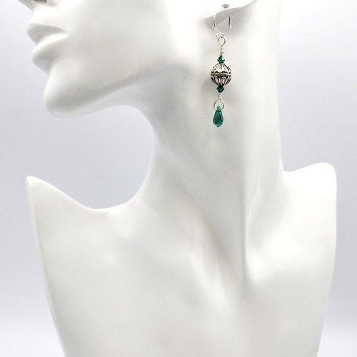 with tiny green crystal beads with dangly teardrop charms at the bottom