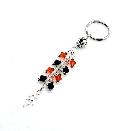 silver skull bead at the top and flame charm at the bottom 