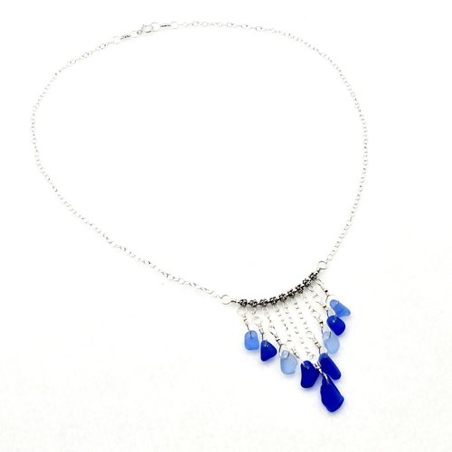 alternating pieces (9) of cobalt blue and cornflower blue tiny charms hang in a V pattern 