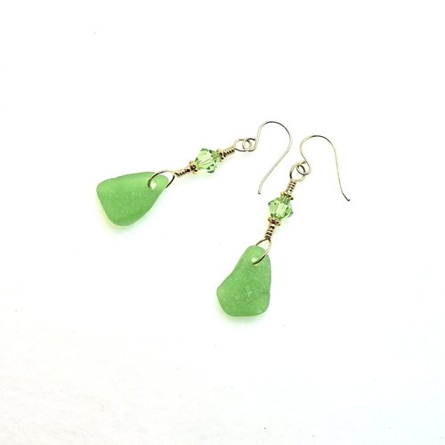 the real sea glass is drilled by me into small charms that dangle at the bottom of the earrings